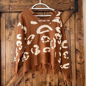 Cheetah sweater with fringe.